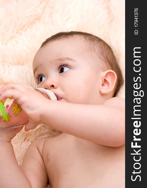 Little caucasian boy drinking water from the bottle