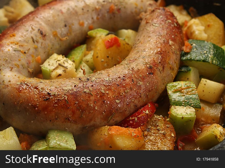 Baked sausage meat with vegetables and spices. Baked sausage meat with vegetables and spices