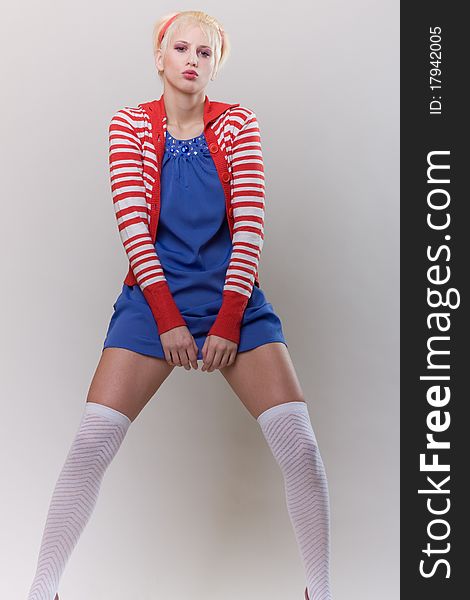 Emotion pose blond girl in red strip woolly