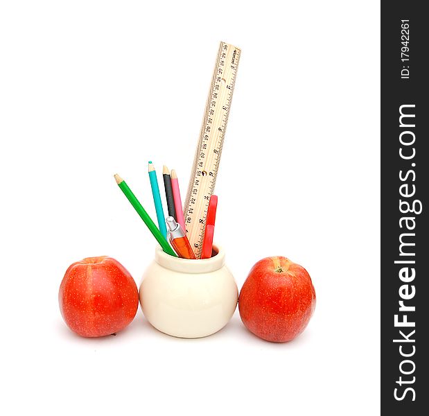 Pencils, pen, ruler and apple