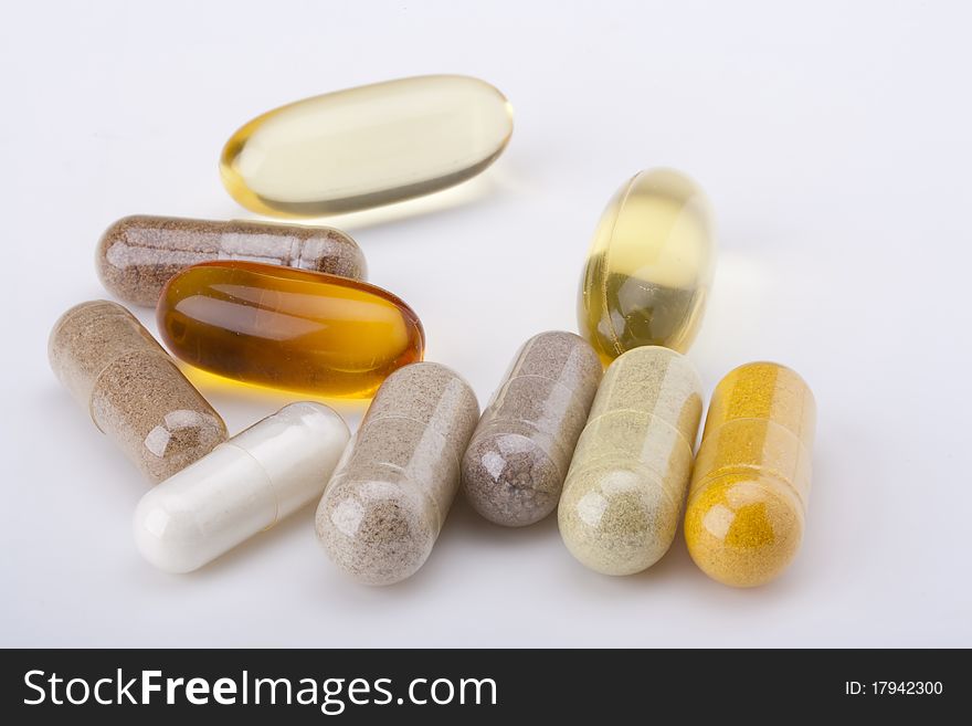 A set of capsules with colored medication for a transparent shell.