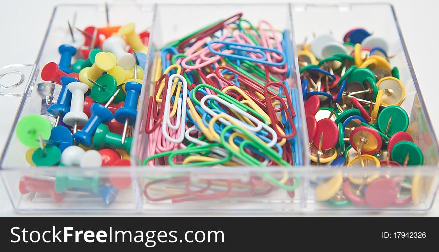 Mix of pins and paper clips in a transparent box