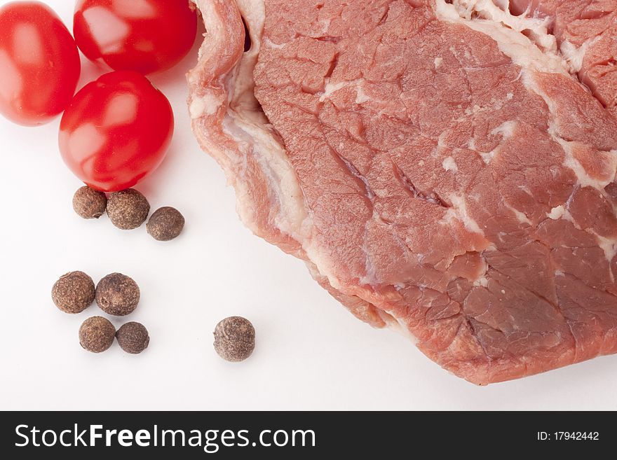 A large piece of raw meat on a white background.