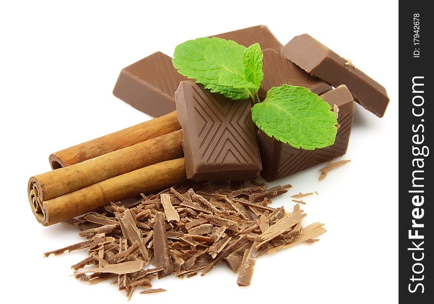Chocolate, cinnamon with mint on a white background. Chocolate, cinnamon with mint on a white background