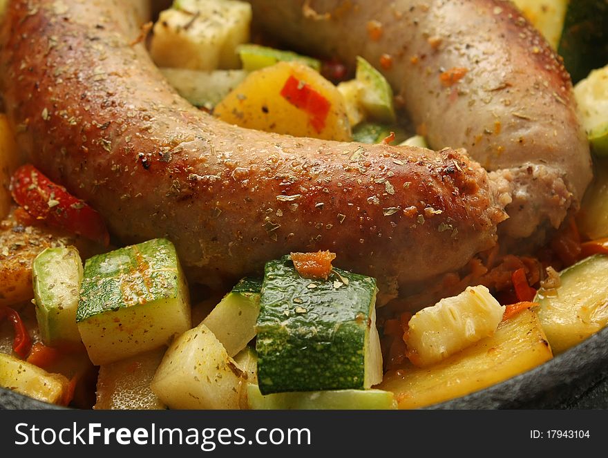 Baked sausage meat with vegetables and spices. Baked sausage meat with vegetables and spices