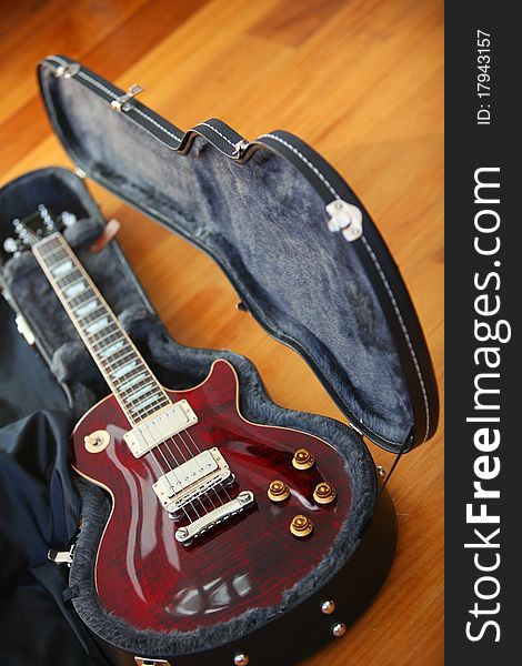 Electric guitar in the black case in the studio.