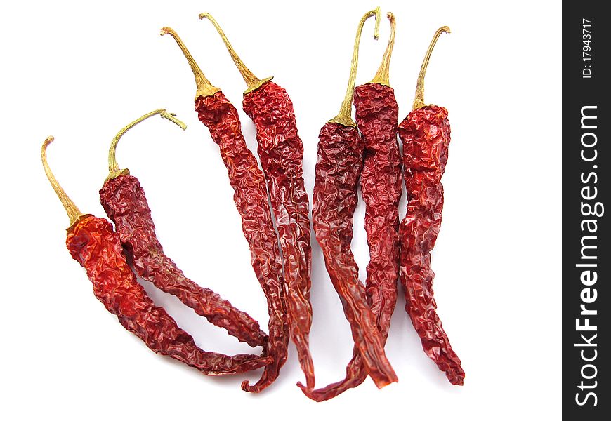 Some dried red chillies isolated on white.