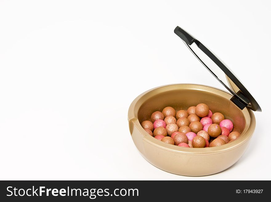 Box with bronzing pearls on white background. Box with bronzing pearls on white background