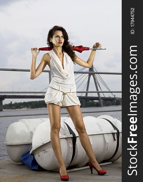 Stylish woman on deck of ship in white dress. Stylish woman on deck of ship in white dress