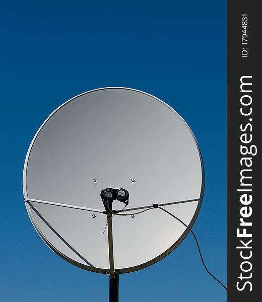 Parabolic antenna on a background of blue sky