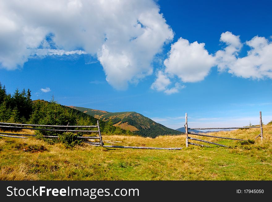 Summer landscape in mountains with the cloudy sky