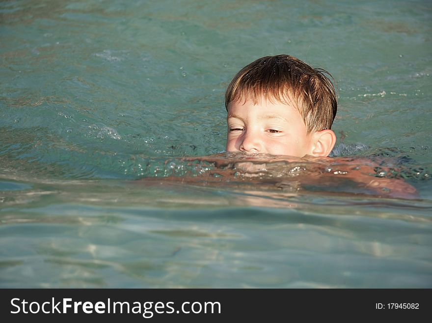 Portrait of young boy swimming
