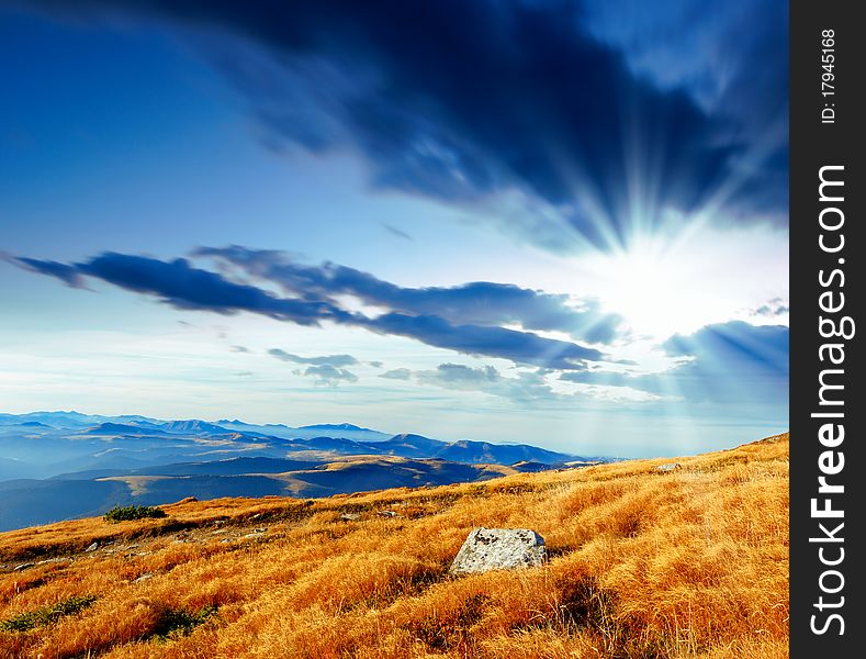 Summer landscape in mountains with the cloudy sky