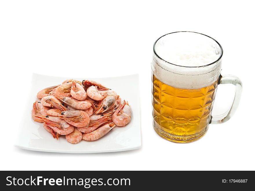 Fresh, cold beer in glass and fried shrimps on plate. Isolated on white background. Fresh, cold beer in glass and fried shrimps on plate. Isolated on white background