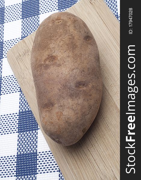 Fresh Potato Food Background on Blue with Wood Kitchen Block.