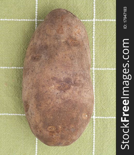 Fresh Raw Potato on Green Kitchen Towel
