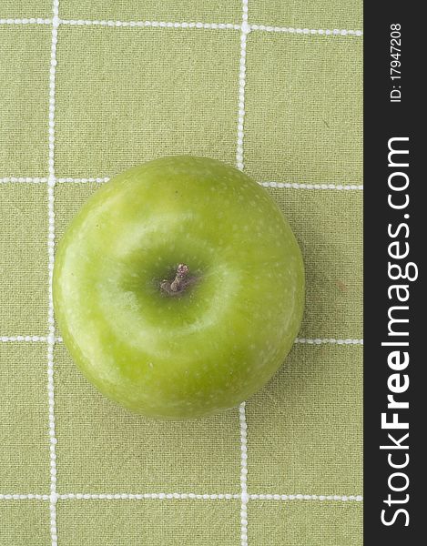 Fresh Green Tart Apple on a Green Background