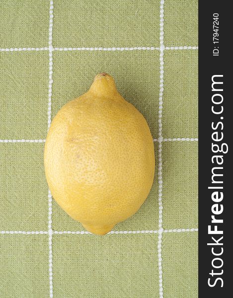 Fresh Lemon on Green Kitchen Towel Background.