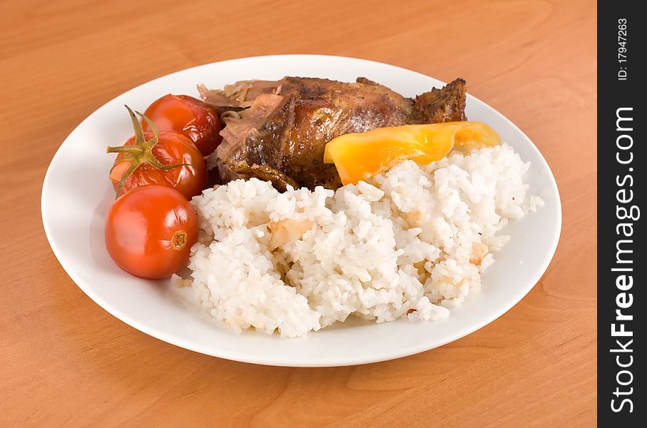 Boiled rice with grilled poultry on the table. Boiled rice with grilled poultry on the table