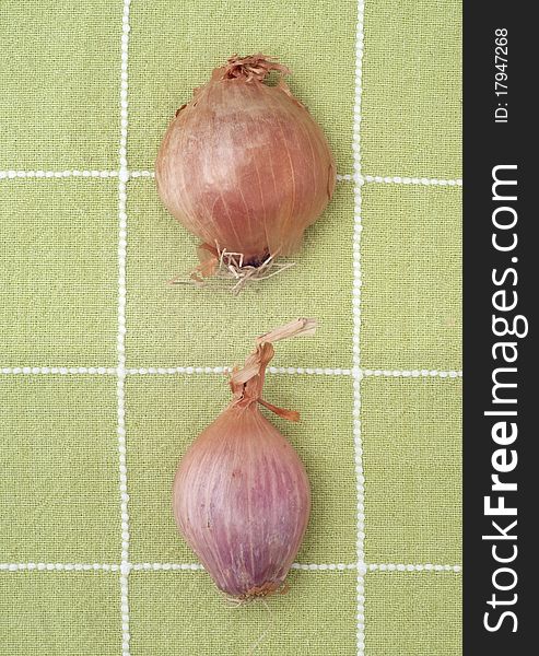 Fresh Pair of Shallots on Green Kitchen Towel