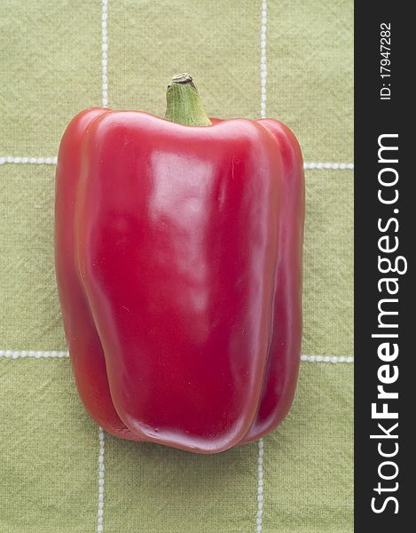 Red Bell Pepper on Green Towel Background.