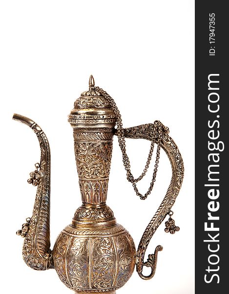 Copper jug with a traditional Arabic ornaments on a white background