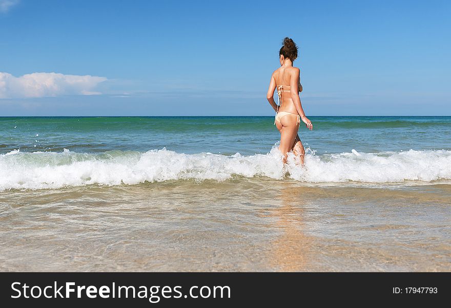 Lovely girl in sea on sunny day