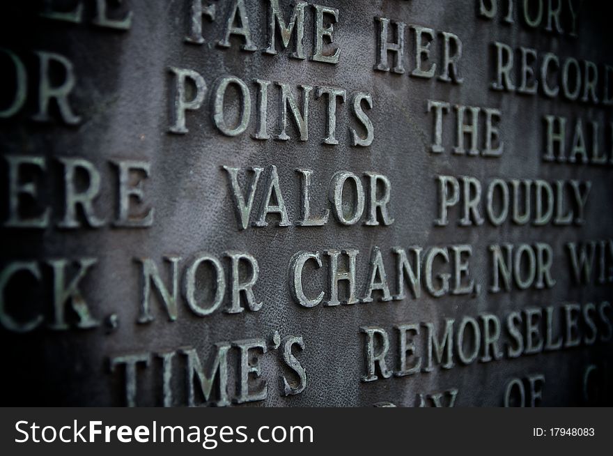 Valor spelled out on a copper monument with vignetting