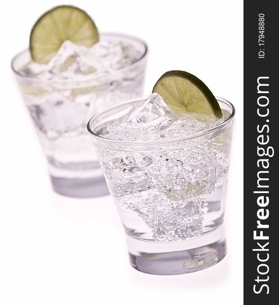 Water with ice and lime on white background