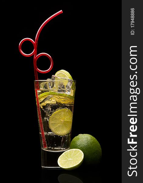 Cocktail with lime on black background. Cocktail with lime on black background