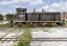 Old Abandoned Locomotive A By A Rail Crossing Sign Stock Photos