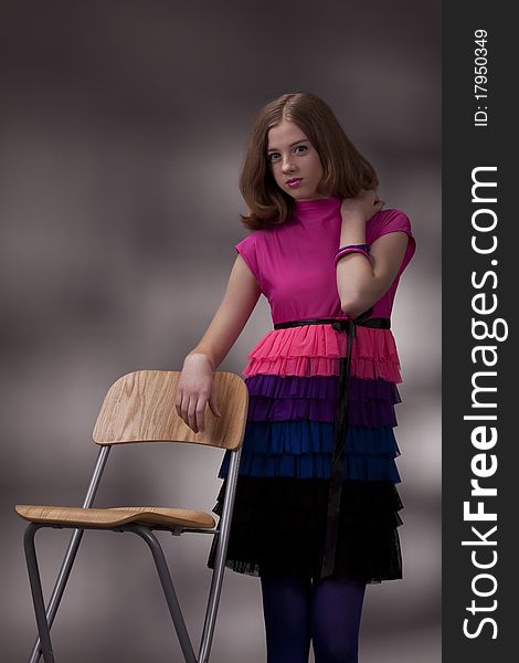 Portrait Of The Brunette On A High Chair