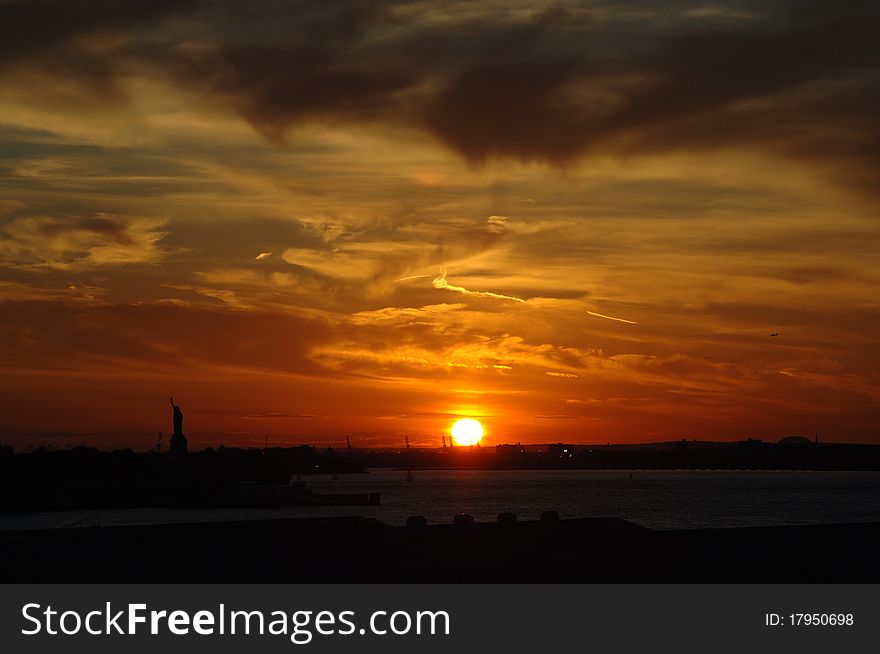Sunset on New York Harbor with Statue of Liberty on left
