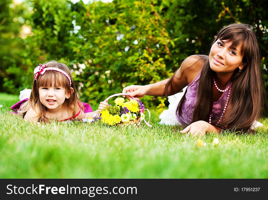 Mother and little girl on the grass