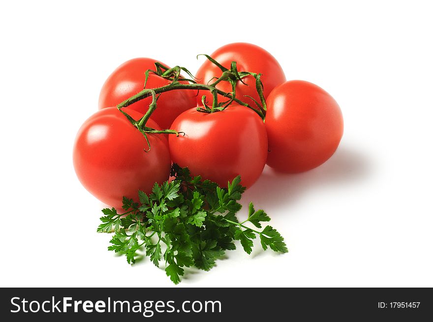 Red tomatoes with parsley isolated on a white background