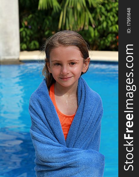 Young girl wrapped in a towel after her swim. Young girl wrapped in a towel after her swim