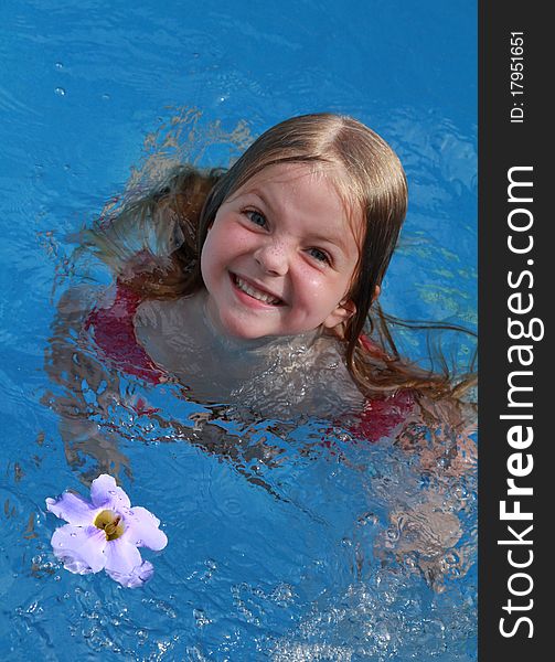 Happy child swimming with flower. Happy child swimming with flower
