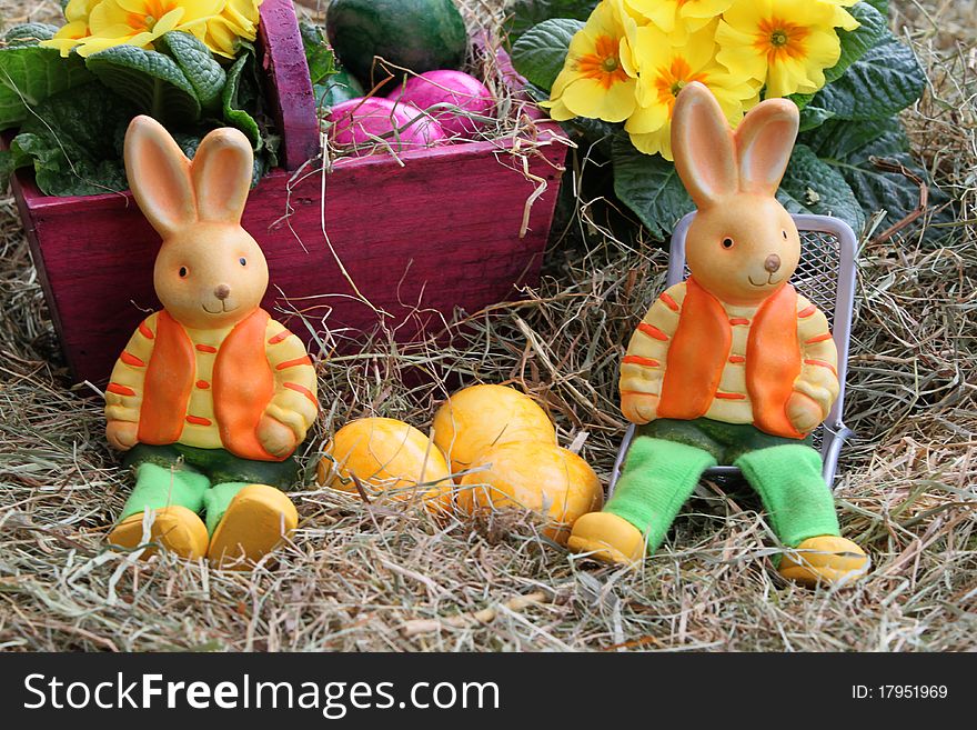 Two Easter bunnies in the hay