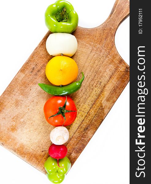 Various vegetables on wooden plate macro