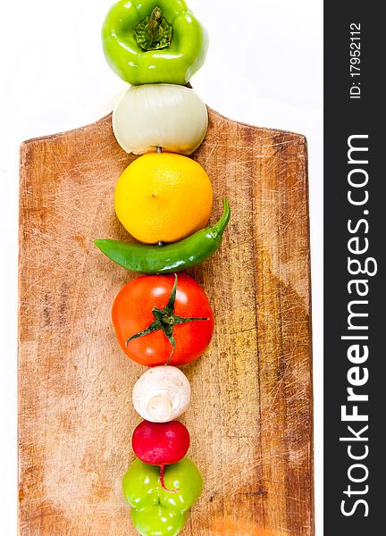 Various vegetables on wooden plate macro