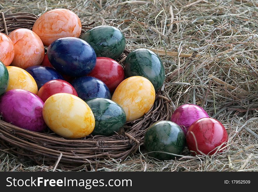 Colored eggs in one basket. Colored eggs in one basket