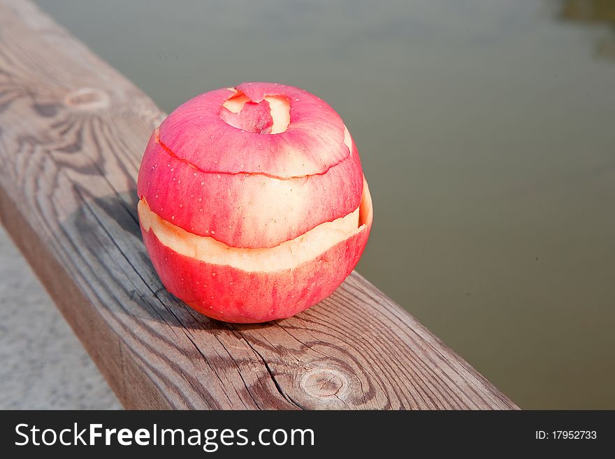 A red peeled apple out of doors. A red peeled apple out of doors.