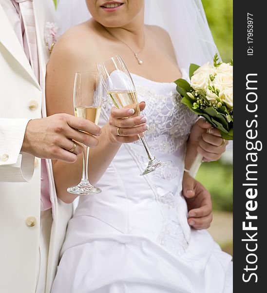 Bride and fiance clink glasses with glasses
