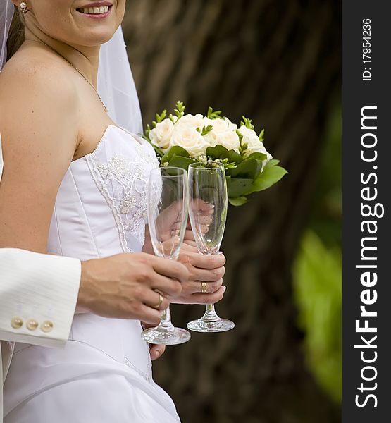 Bride and fiance are holding empty glass. Bride and fiance are holding empty glass