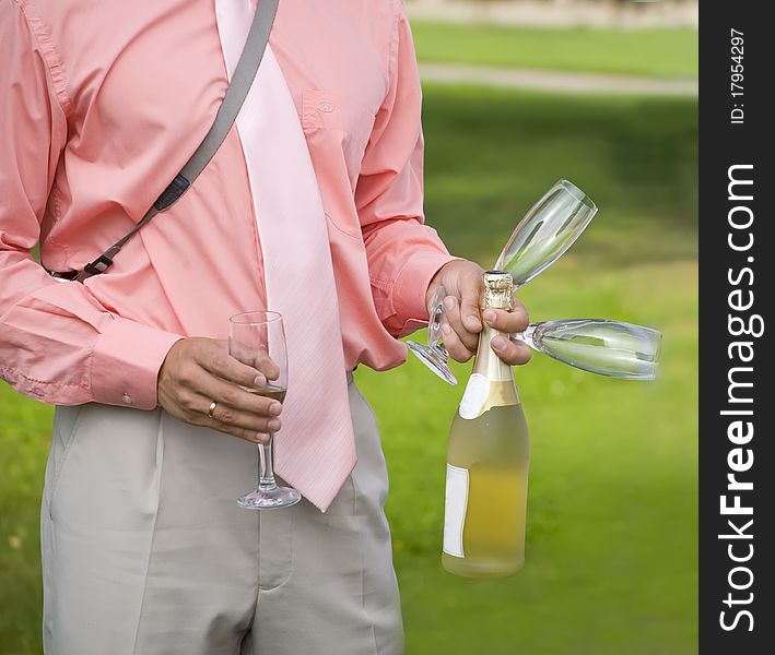 Man with champagne and glasses is ready to take a part in celebration. Man with champagne and glasses is ready to take a part in celebration