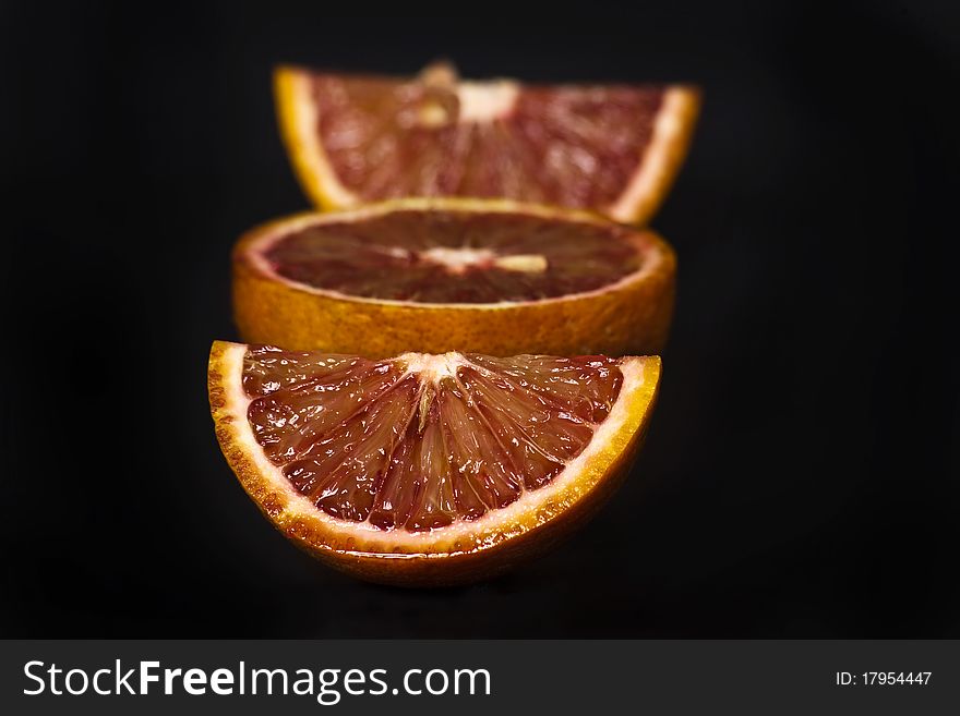 Orange slice shot in the studio isolated on black. Orange slice shot in the studio isolated on black