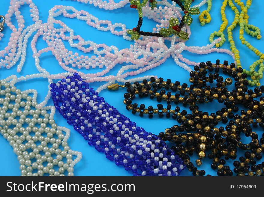 Homemade products from beads on a blue background. Homemade products from beads on a blue background
