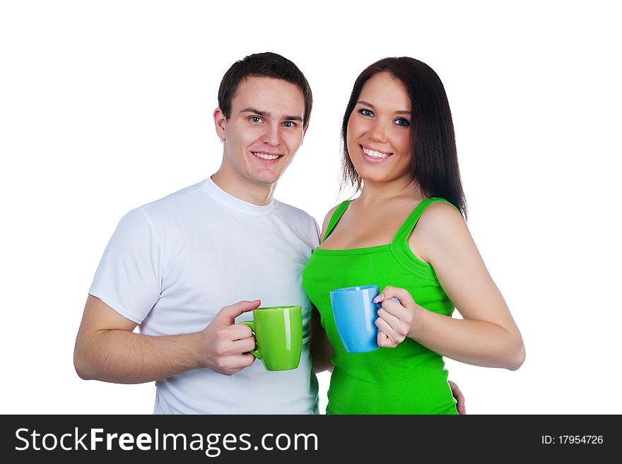 Young couple with a cups of tea over white background