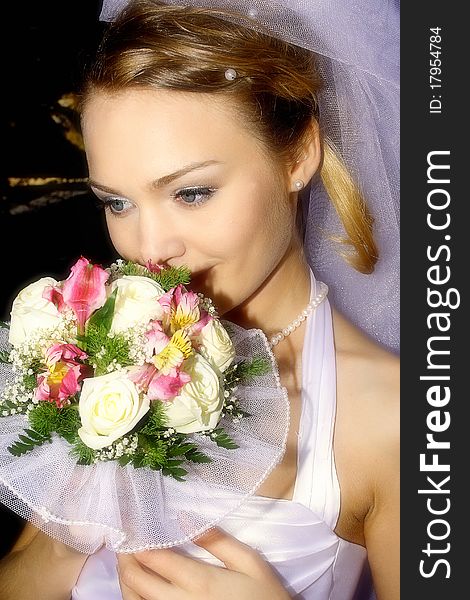 The gentle, beautiful, is mysterious-romantic bride with a wedding bouquet. The gentle, beautiful, is mysterious-romantic bride with a wedding bouquet