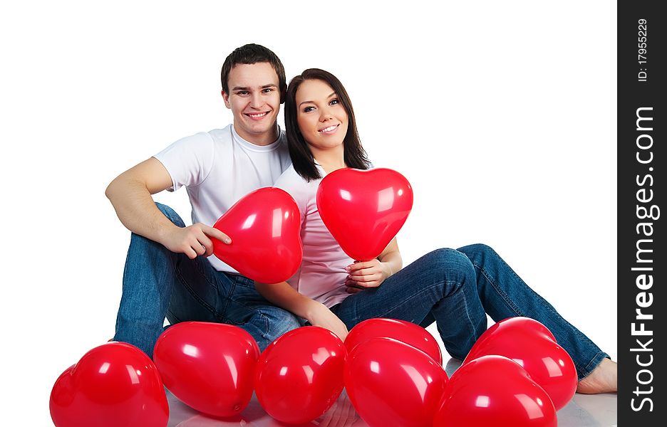 Young couple with a hearts over white background